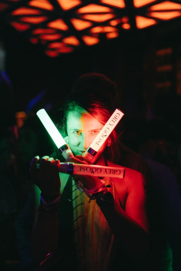 Guest holding Grey Goose branded light sticks