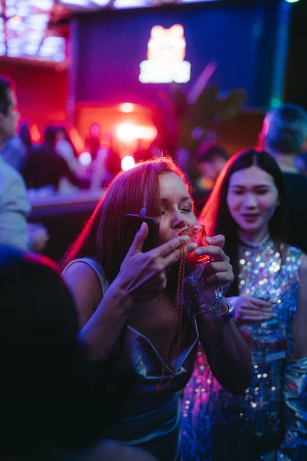 Guest enjoying a Patrón necklace shot